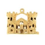 A 9ct gold castle charm.Hallmarks for London, 1974.Length 2.1cms.