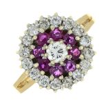 A 9ct gold ruby and diamond cluster ring.Principal diamond estimated 0.20ct,