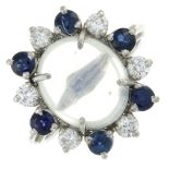 A moonstone, sapphire and diamond cluster ring.Estimated total diamond weight 0.40ct.