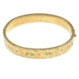 A 9ct gold bangle, with engraved floral half bangle.Hallmarks for 9ct gold.