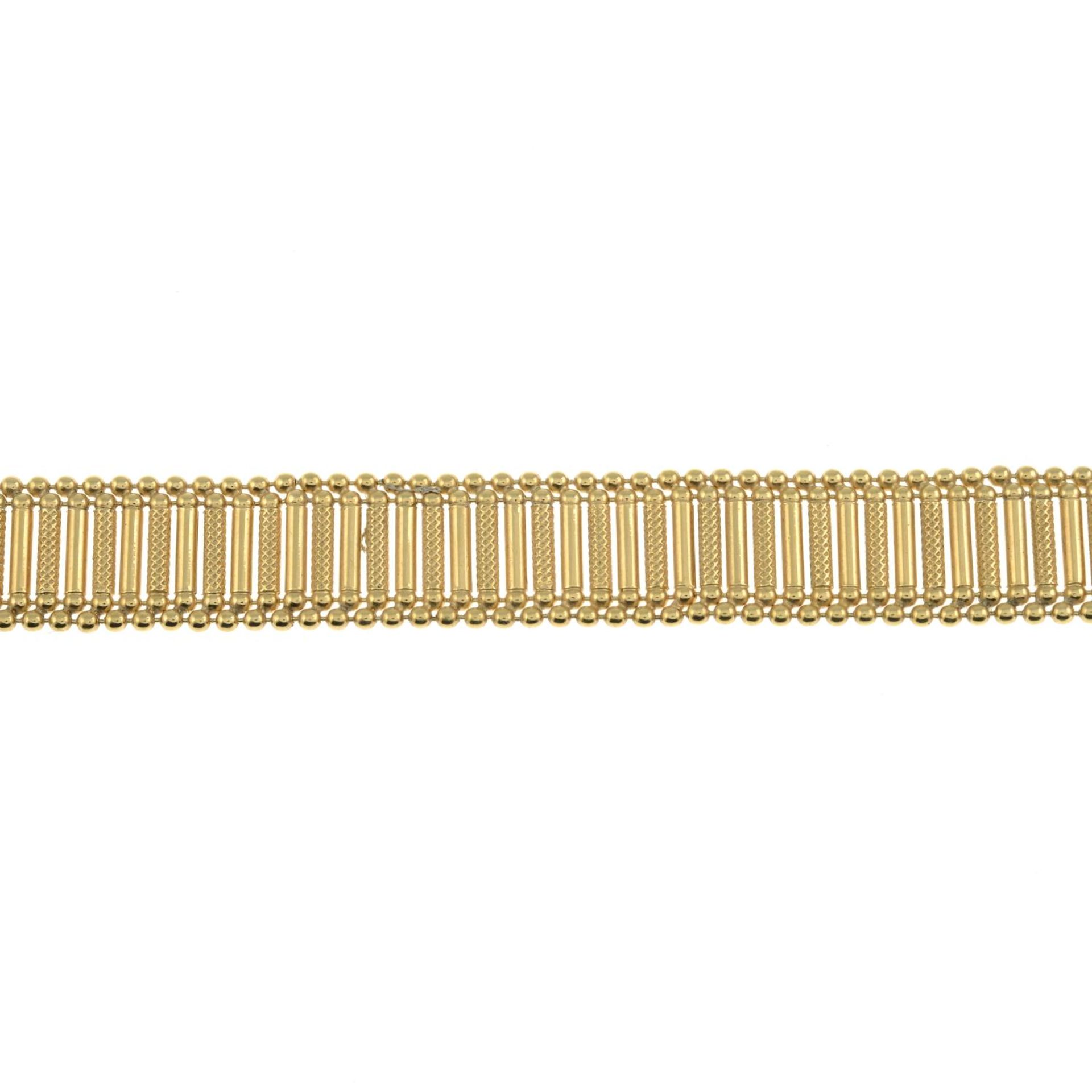 A 9ct gold polished and textured fancy-link bracelet.Import marks for 9ct gold.