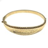 A mid 20th 9ct gold engraved hinged bangle, by Smith and Pepper.Hallmarks for Birmingham, 1967.