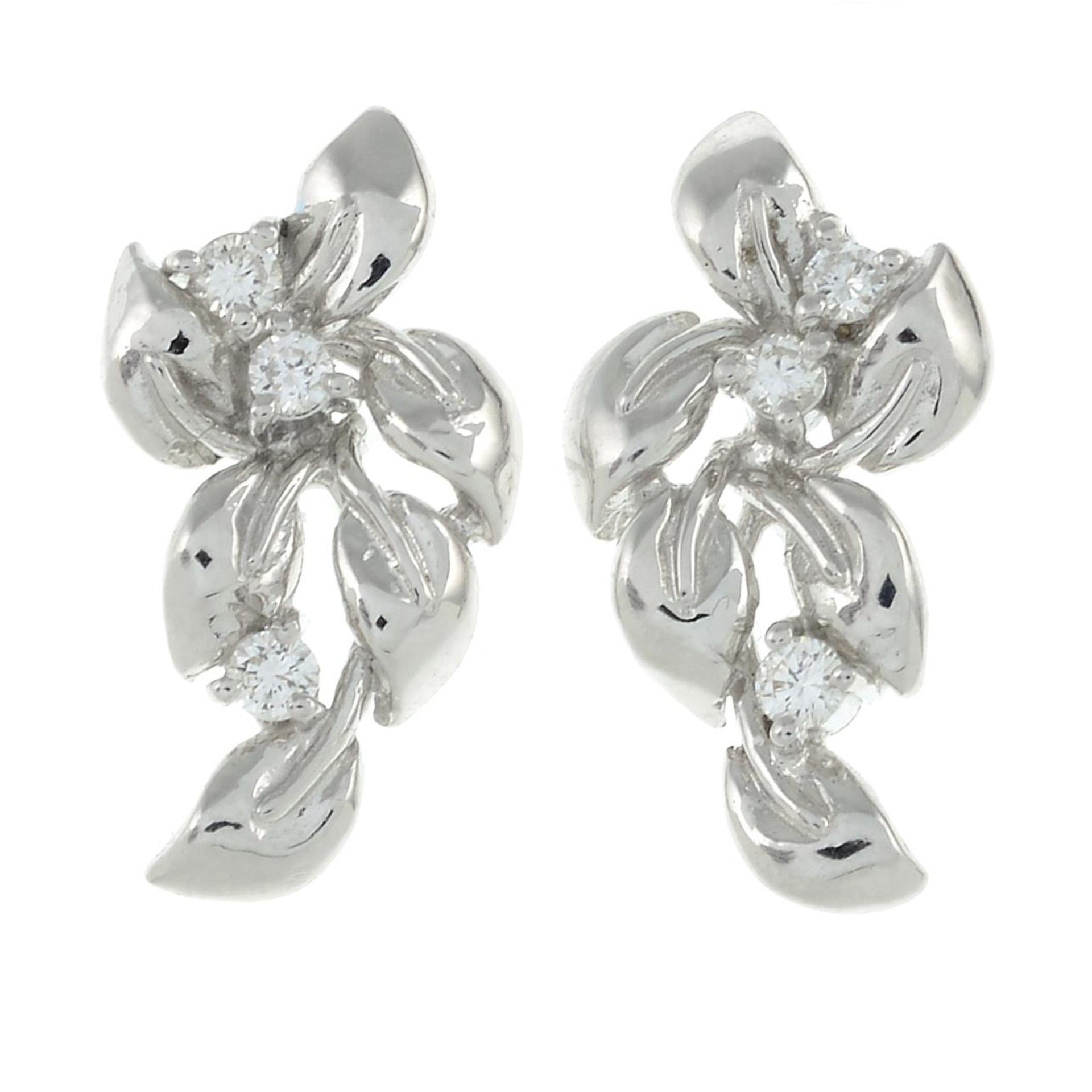 A pair of brilliant-cut diamond foliate stud earrings.Estimated total diamond weight 0.10ct.Stamped