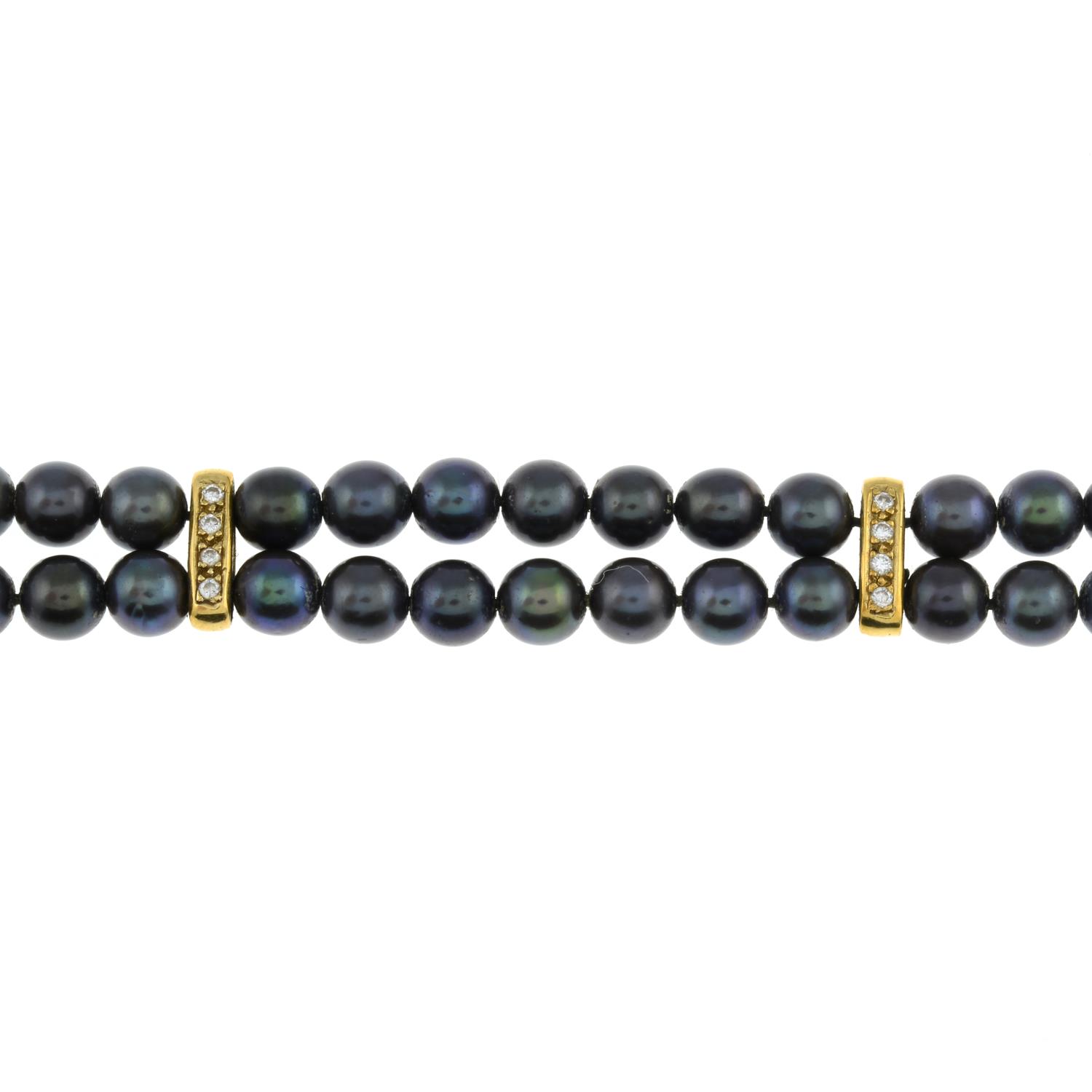 An 18ct gold pearl and diamond bracelet.Estimated total diamond weight 0.20ct.