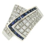 A brilliant-cut diamond and sapphire crossover ring.Estimated total diamond weight 0.80ct.Stamped