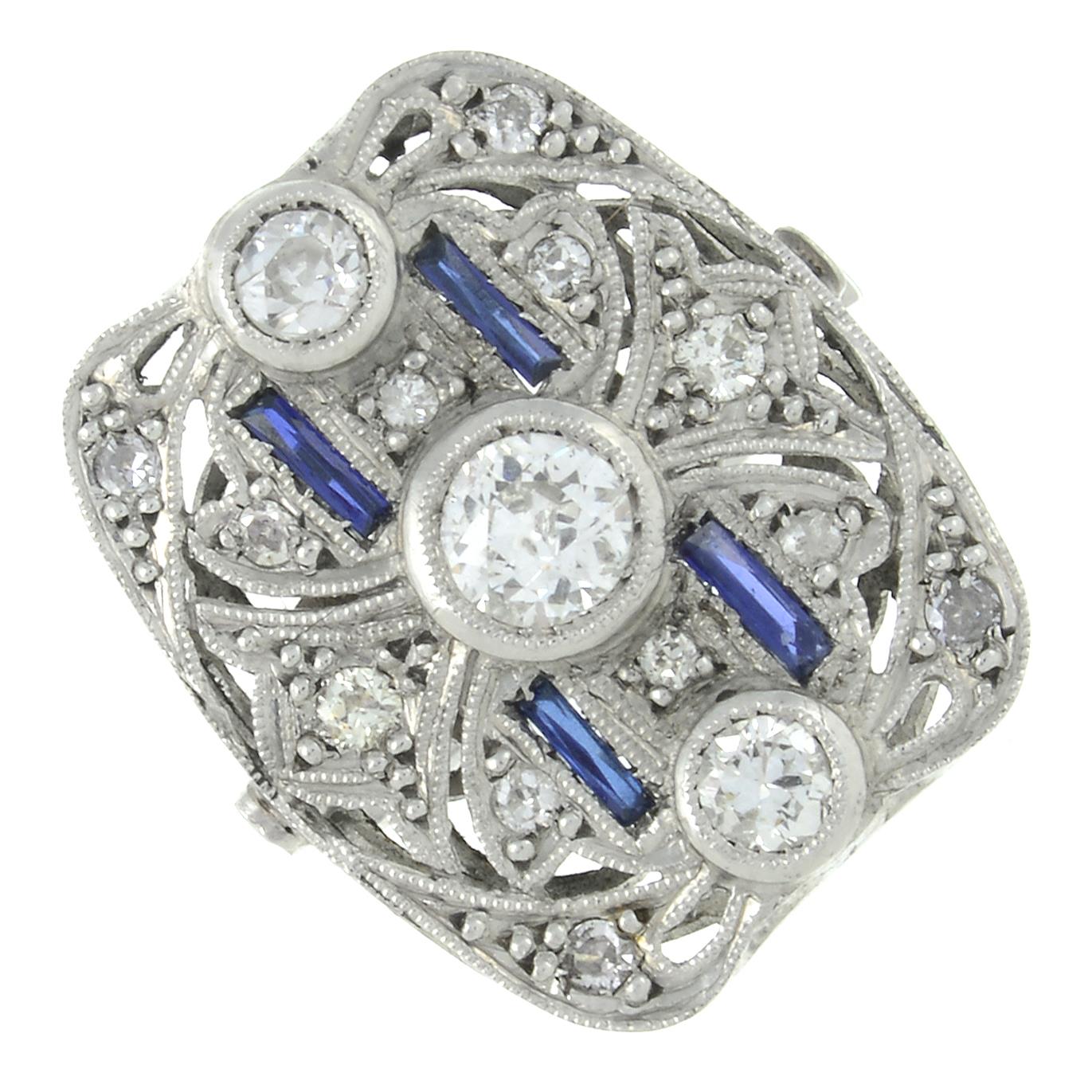 A sapphire and old-cut diamond cluster ring.Estimated total diamond weight 0.60ct,