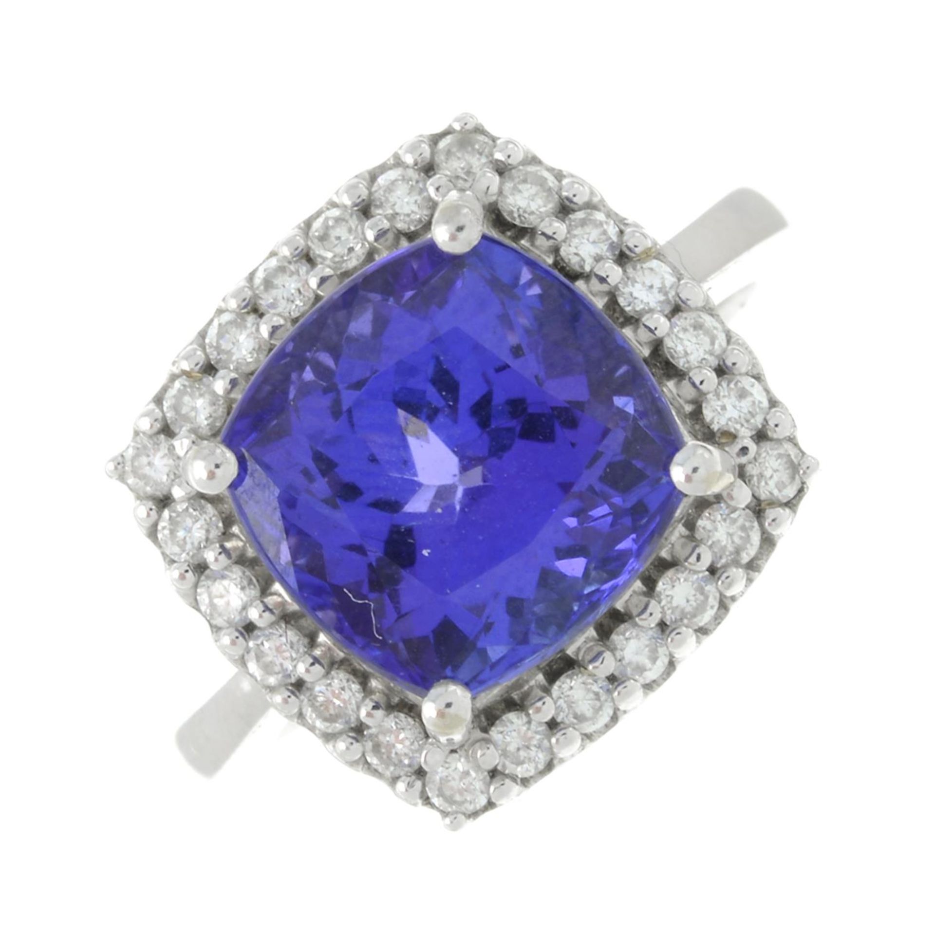 An 18ct gold tanzanite and brilliant-cut diamond cluster ring.Tanzanite calculated weight 5.92cts,