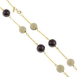 A fancy-link chain, set with a series of alternating garnet and smoky quartz beads.