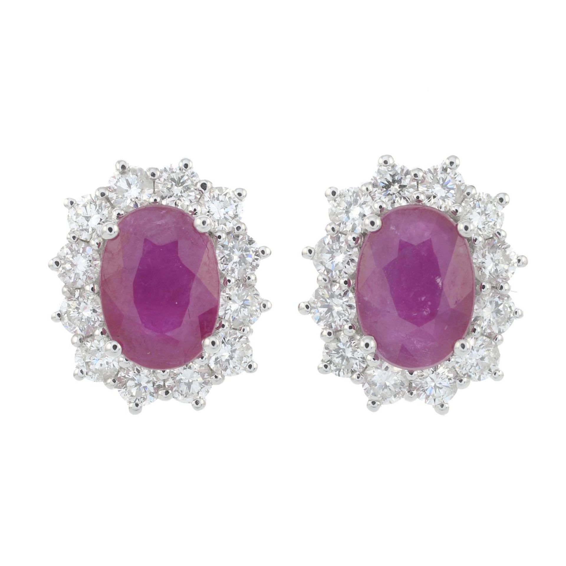 A pair of 18ct gold ruby and brilliant-cut diamond cluster earrings.Total diamond weight 0.70cts,