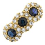 An 18ct gold sapphire and brilliant-cut diamond triple cluster ring.Estimated total diamond weight