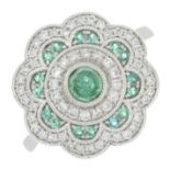 An 18ct gold emerald and brilliant-cut dress ring.Total diamond weight 0.31ct,