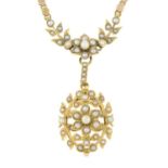 An early 20th century gold seed pearl floral pendant, suspended from a circular-shape link chain.