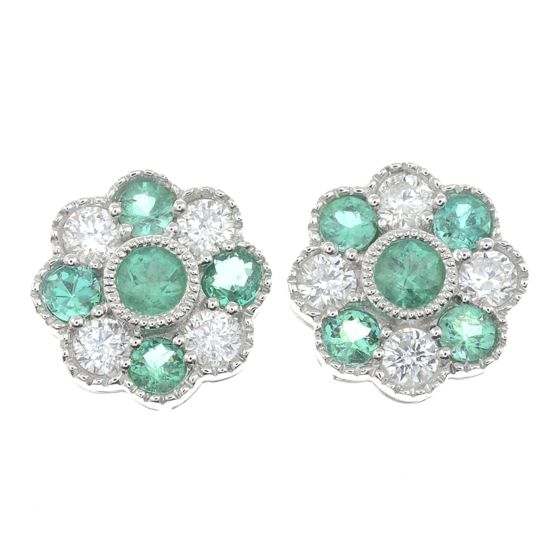 A pair of 18ct gold emerald and brilliant-cut diamond cluster earrings.Total emerald weight