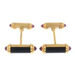 A pair of 18ct gold onyx cufflink, with ruby cabochon terminals.