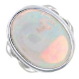 An opal cabochon single-stone ring.Estimated dimensions of opal 21.2 by 15 by 11.2mms.Ring size P.