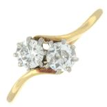 A diamond two-stone crossover ring.Estimated total diamond weight 0.70ct,