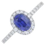 An 18ct gold sapphire and diamond cluster ring.Sapphire calculated weight 0.97ct,