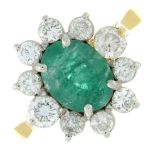 An emerald and brilliant-cut diamond cluster ring.Emerald calculated weight 1.30cts,