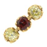 A garnet and 'yellow' old-cut diamond three-stone stone ring.Estimated total diamond weight 0.80ct,