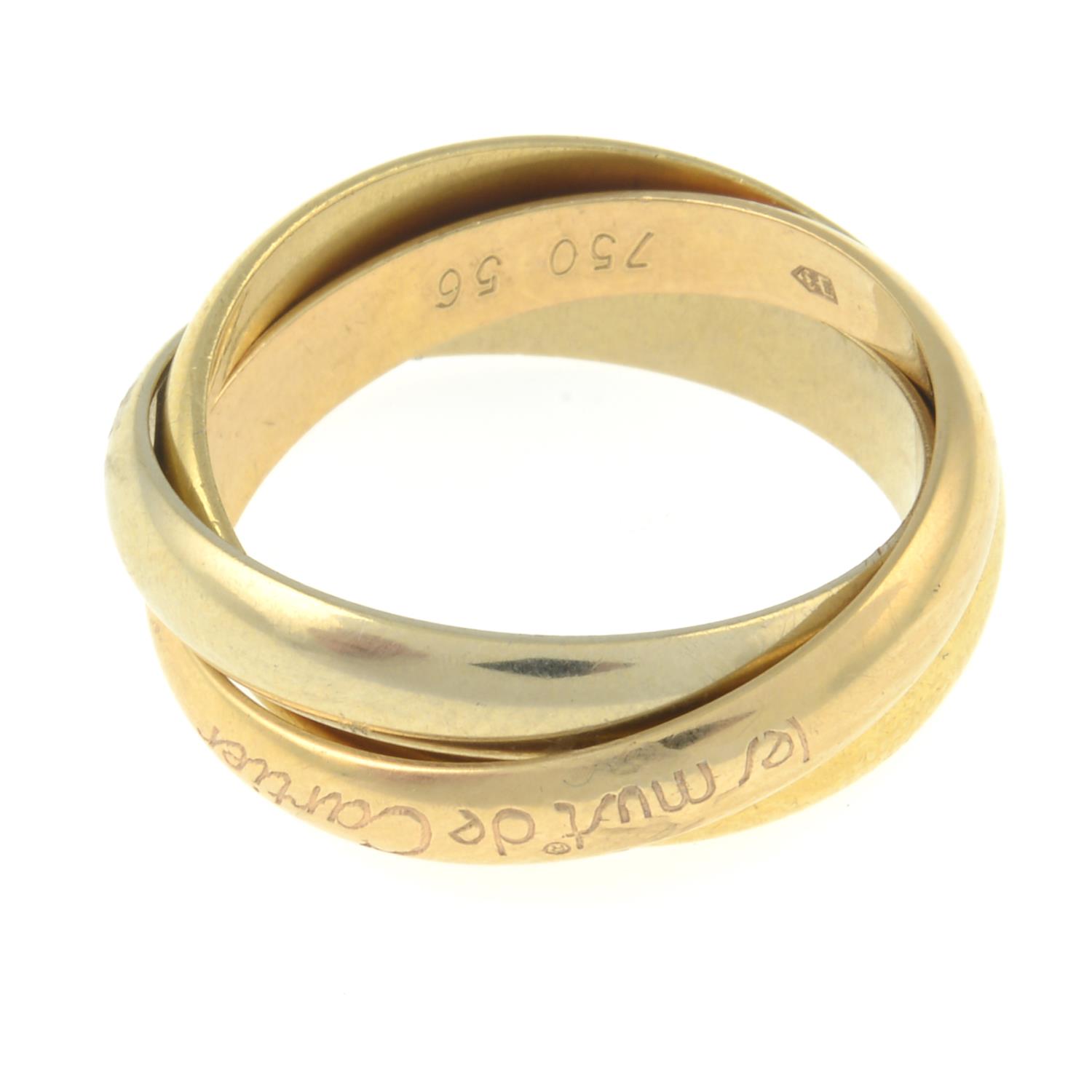 A 'les must de Cartier, Trinity' ring, by Cartier.Signed Cartier.Stamped 750.Ring size O. - Image 2 of 2