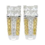 A pair of vari-cut diamond and 'yellow' diamond earrings.Estimated total diamond weight