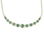 An emerald and brilliant-cut diamond bi-colour necklace.Largest emerald calculated weight 0.71ct,