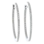 A pair of 18ct gold brilliant-cut diamond hoop earrings.Total diamond weight 0.62ct.Hallmarks for