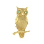 A textured owl brooch, with emerald eye details.Stamped 14k.Length 3.2cms.