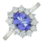 An 18ct gold tanzanite and brilliant-cut diamond cluster ring.Tanzanite weight 1.15cts.Total