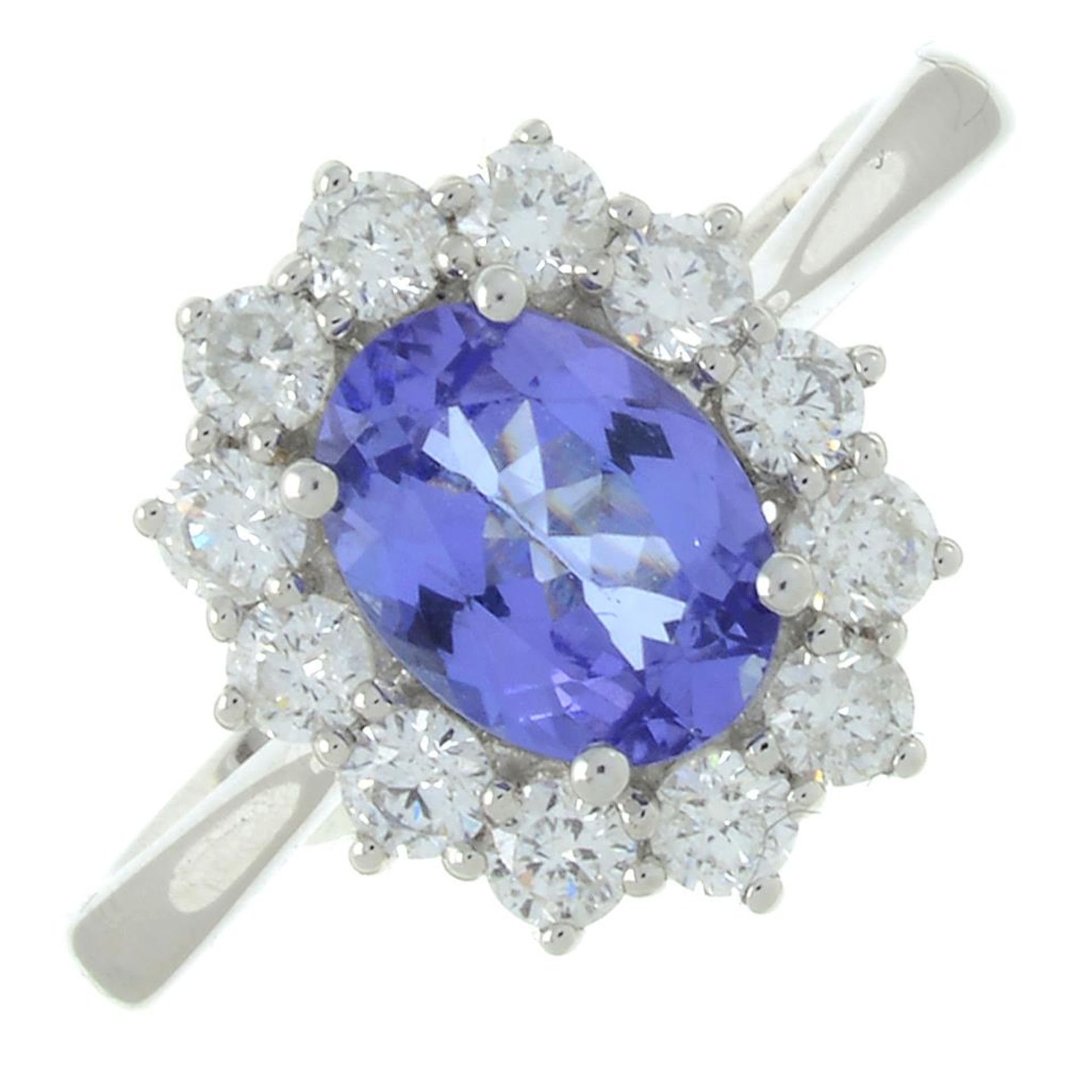 An 18ct gold tanzanite and brilliant-cut diamond cluster ring.Tanzanite weight 1.15cts.Total