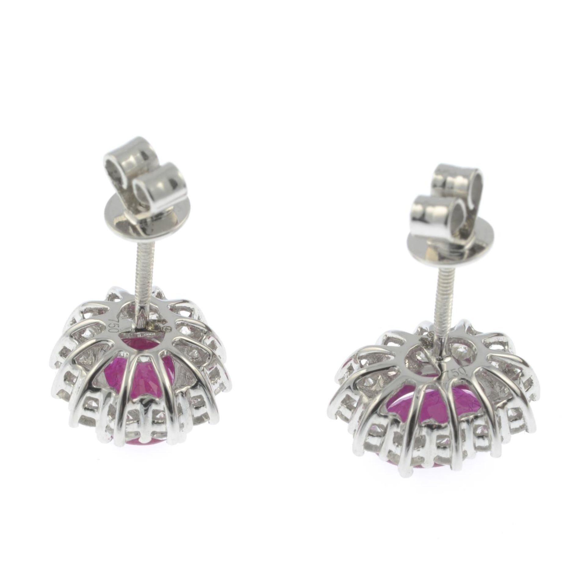 A pair of 18ct gold ruby and brilliant-cut diamond cluster earrings.Total diamond weight 0.70cts, - Image 2 of 2