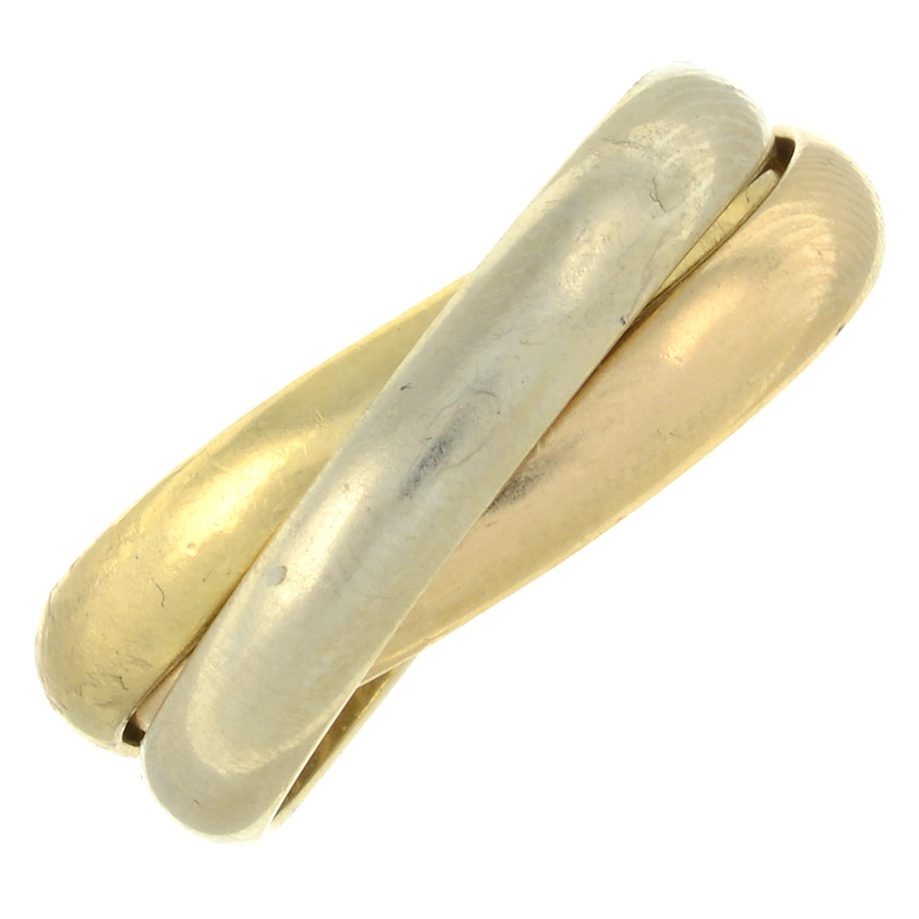 A 'les must de Cartier, Trinity' ring, by Cartier.Signed Cartier, A6359L.Stamped 750.Ring size O.