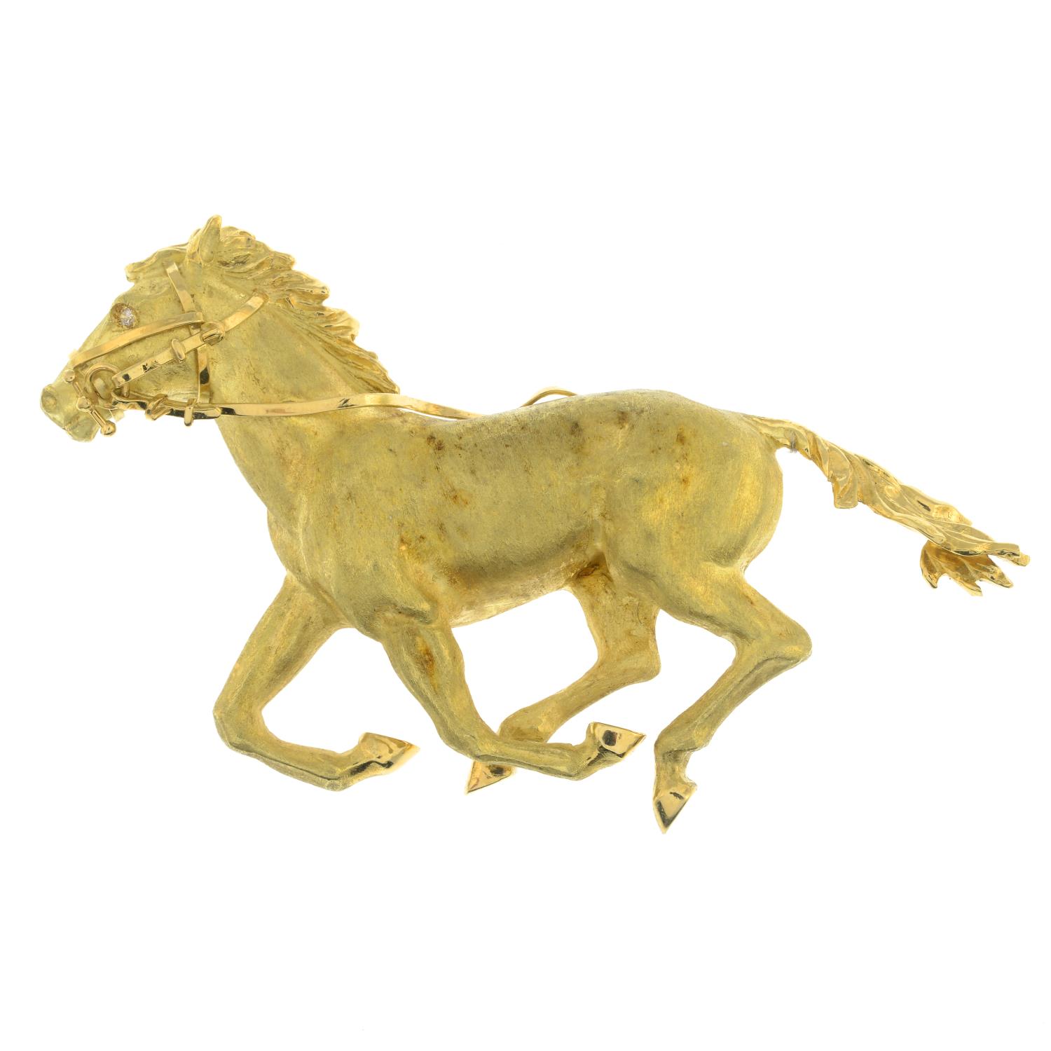An 18ct gold galloping horse brooch, with diamond accent eye.French assay marks.Length 7.2cms.