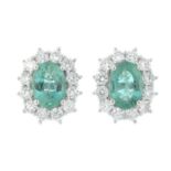 A pair of 18ct gold emerald and brilliant-cut diamond cluster earrings.Total diamond weight 0.86ct,