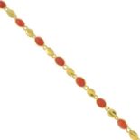 An 18ct gold coral cabochon necklace.Import marks for Sheffield.Length 41cms.