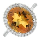 An 18ct gold citrine and brilliant-cut diamond oval-shape cluster ring.Citrine weight 4.12cts.Total
