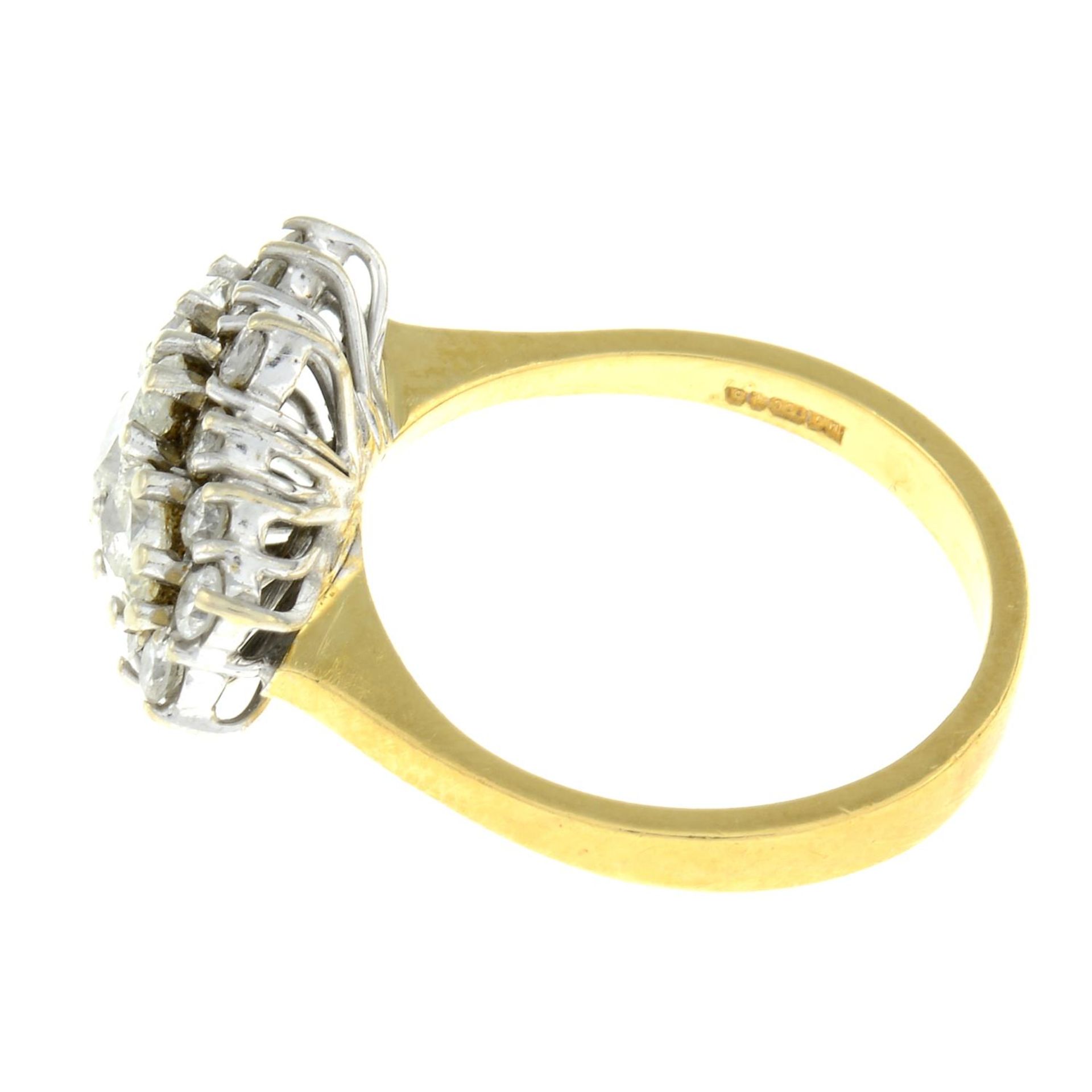 An 18ct gold pear-shape three-stone ring, within a brilliant-cut diamond surround. - Image 2 of 3