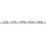 A 9ct gold tanzanite and single-cut diamond bracelet.Total tanzanite weight 7.70cts,