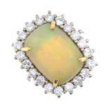 An opal cabochon and brilliant-cut diamond cluster ring.Estimated dimensions of opal 14.9 by 10.8