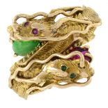 A gem-set serpent ring.Gems to include jade, emerald and synthetic ruby.