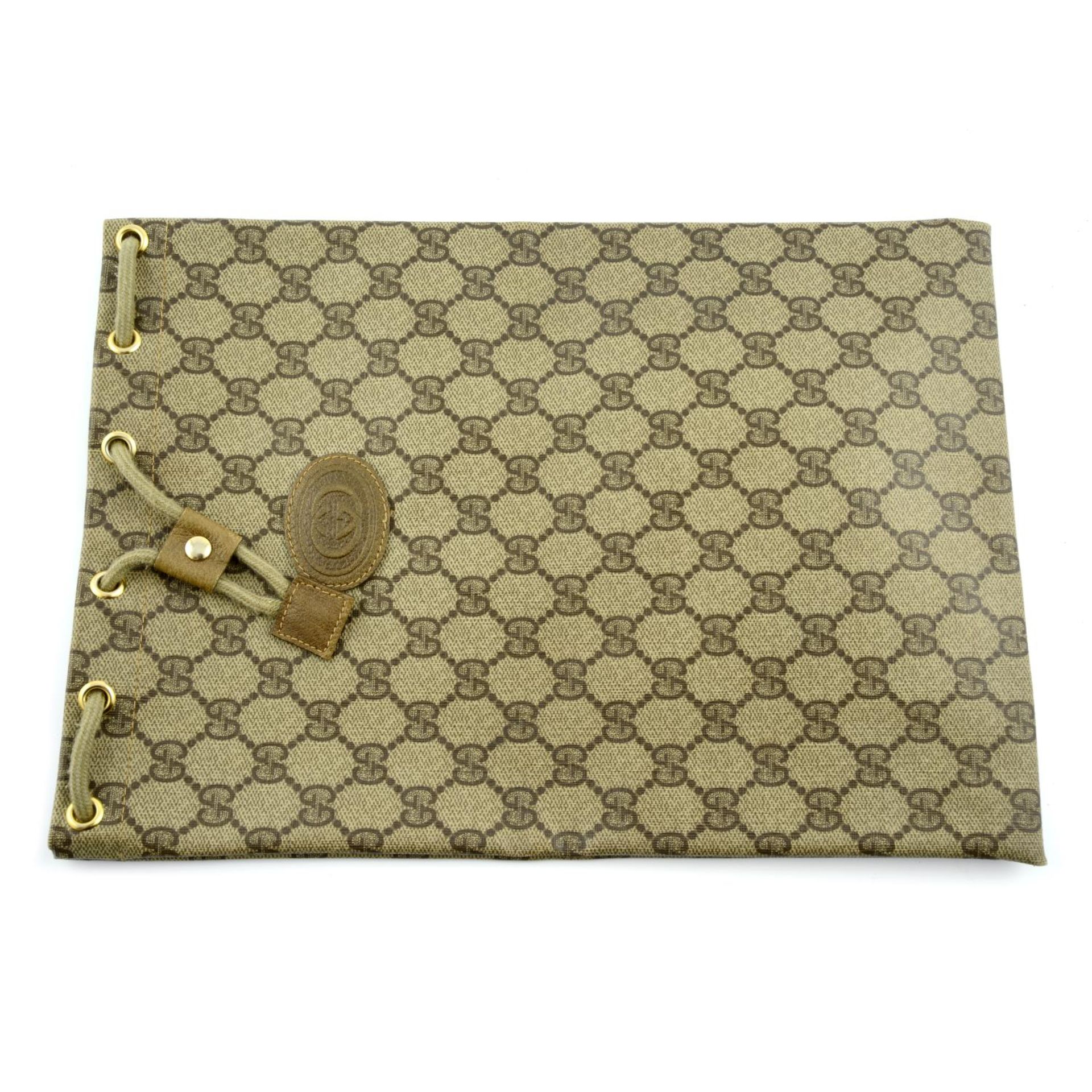 GUCCI - a monogram Supreme coated canvas pouch.