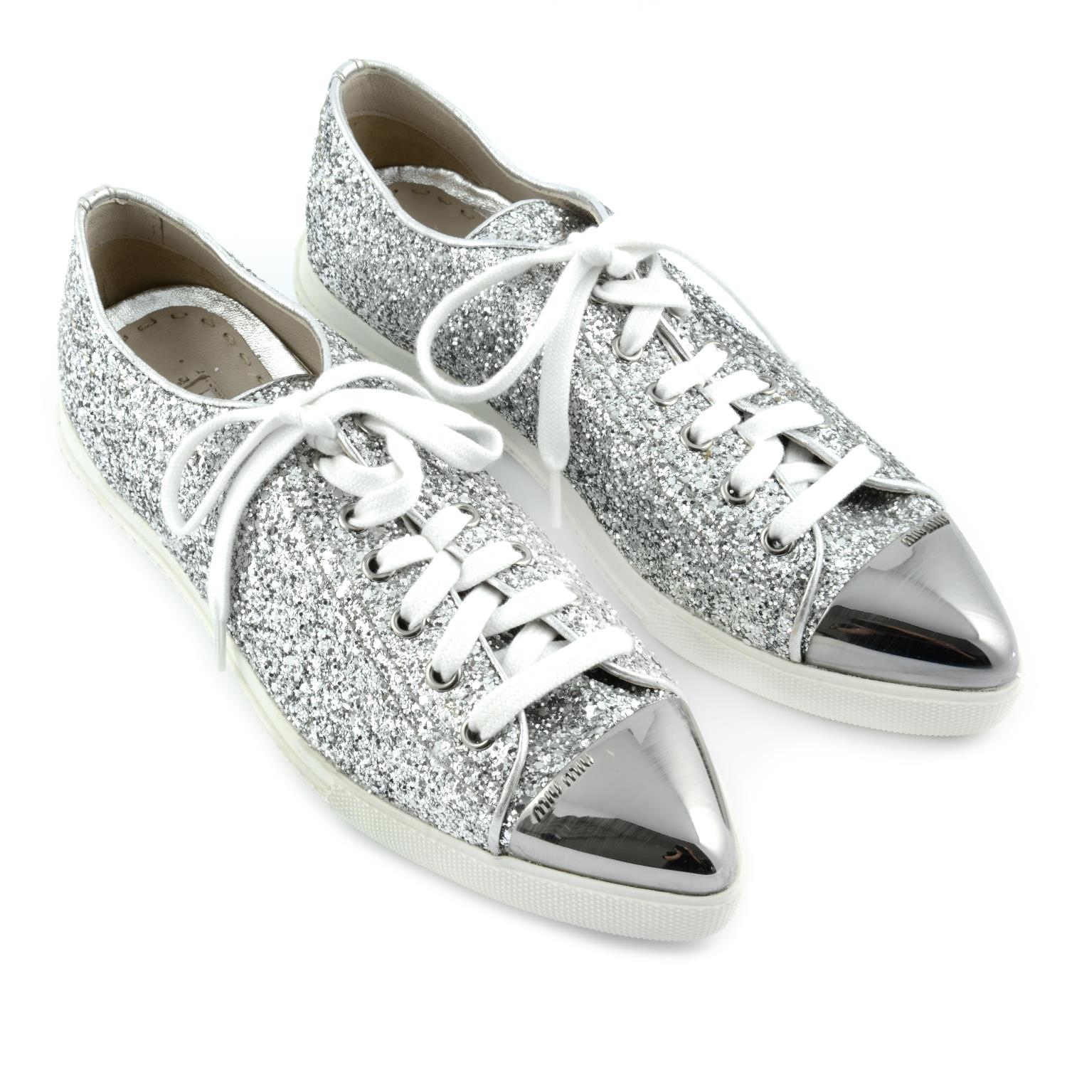 MIU MIU - a pair of silver glitter trainers.
