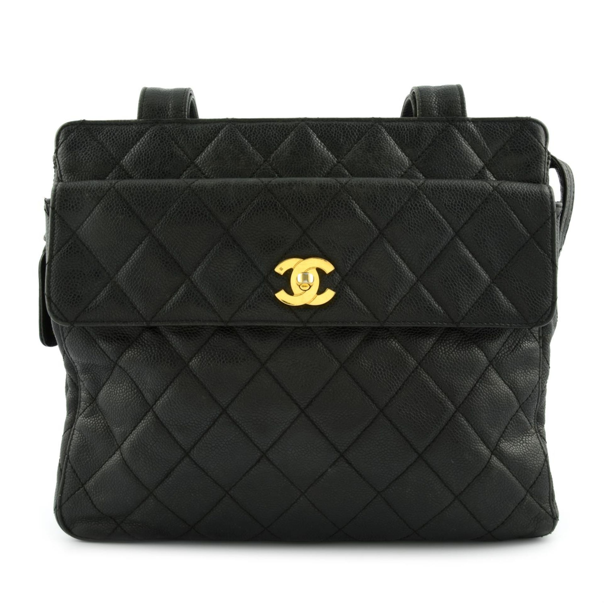 CHANEL - a vintage black caviar leather Petite Shopping Tote handbag.