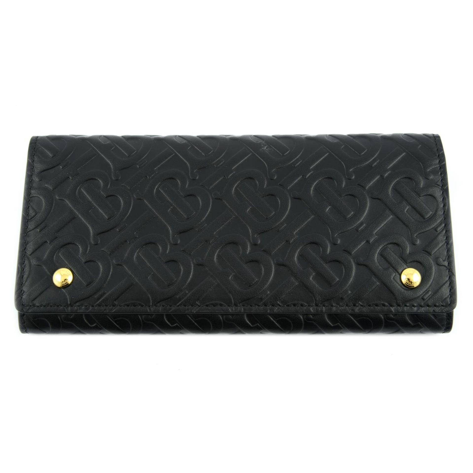 BURBERRY - a black leather monogram continental wallet.