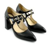 PRADA - a pair of black leather Mary Jane heeled pumps.