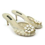 DOLCE & GABBANA - a pair of cream lace embellished sandals.