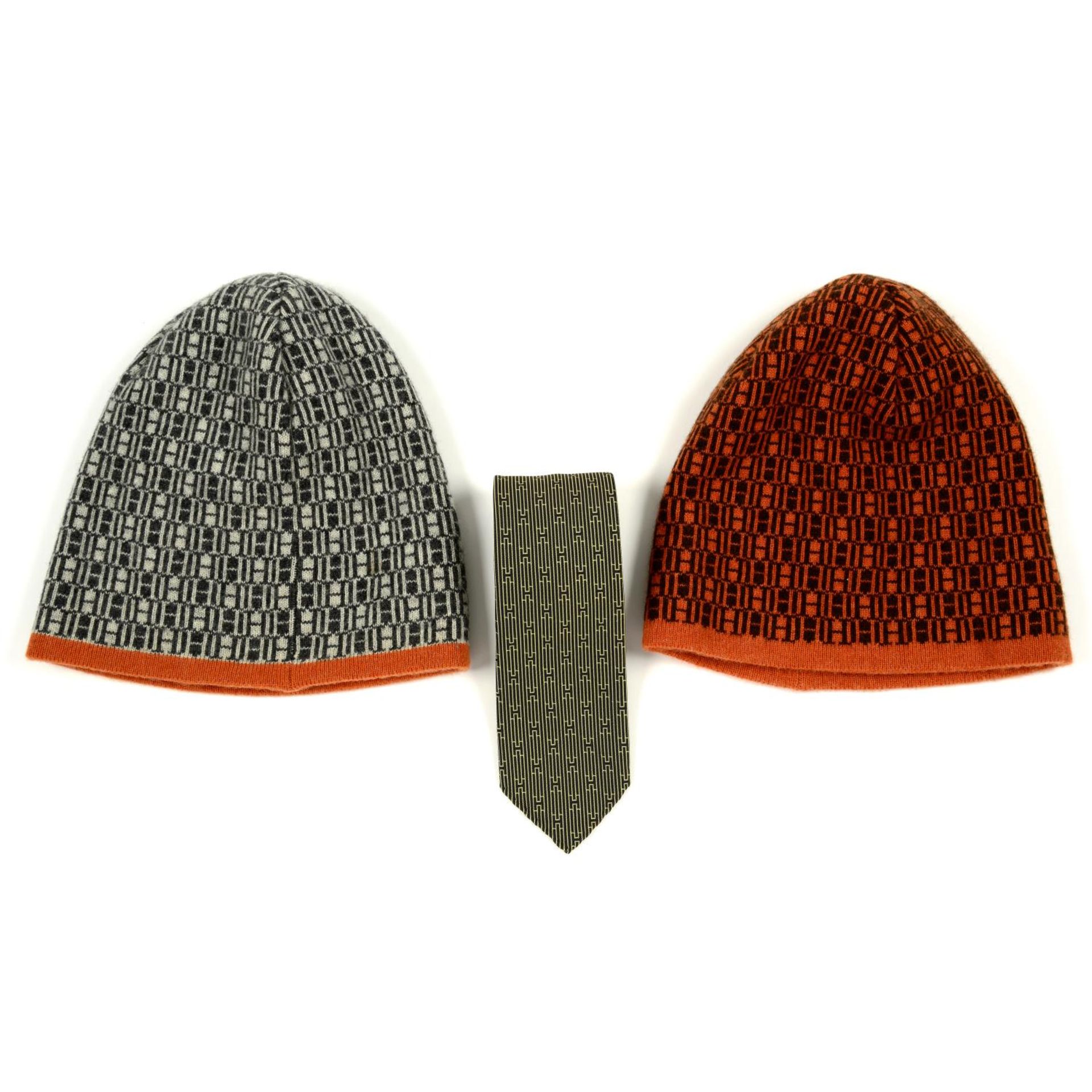 HERMÈS - a silk tie and two wool beanie hats.
