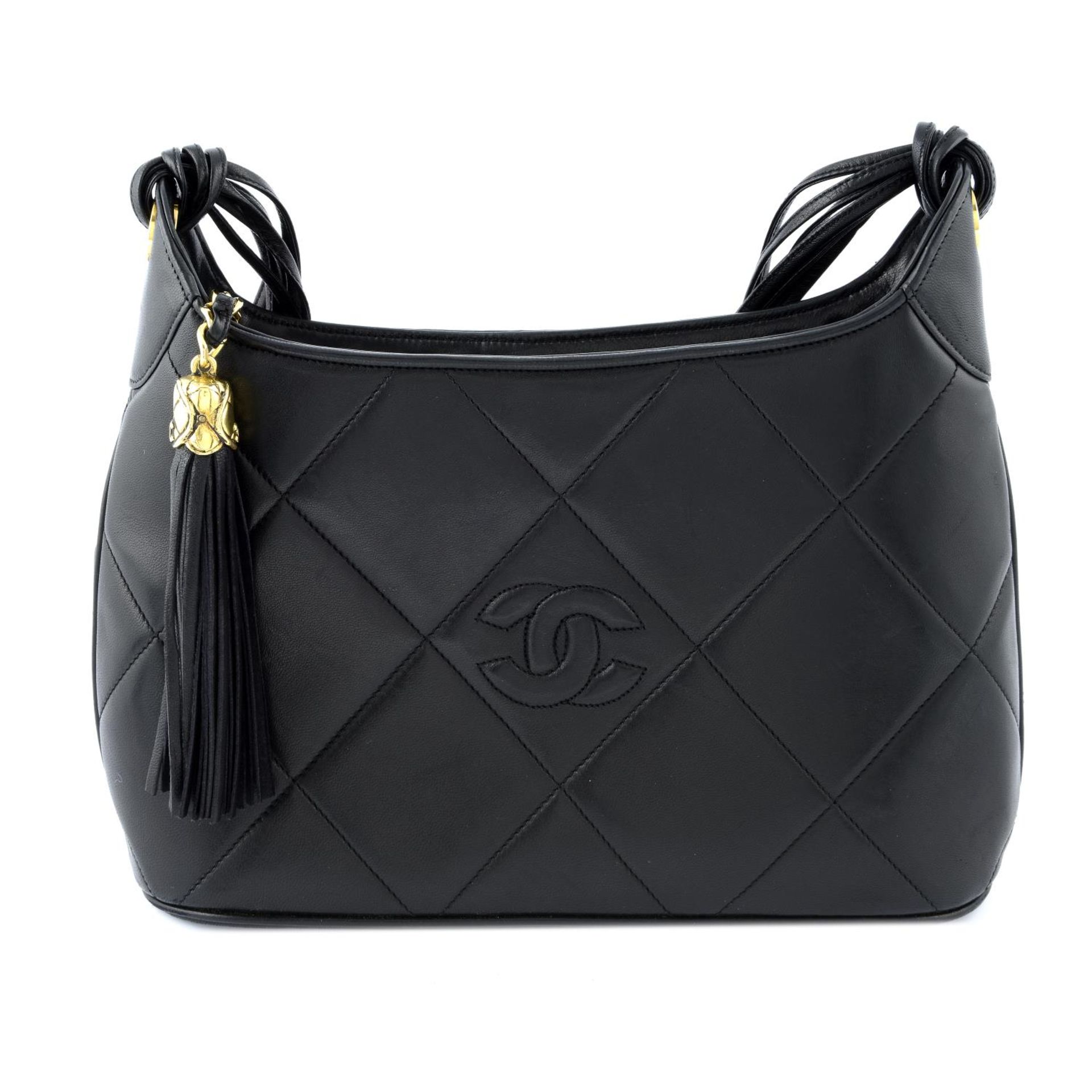 CHANEL - a black diamond quilted leather handbag.