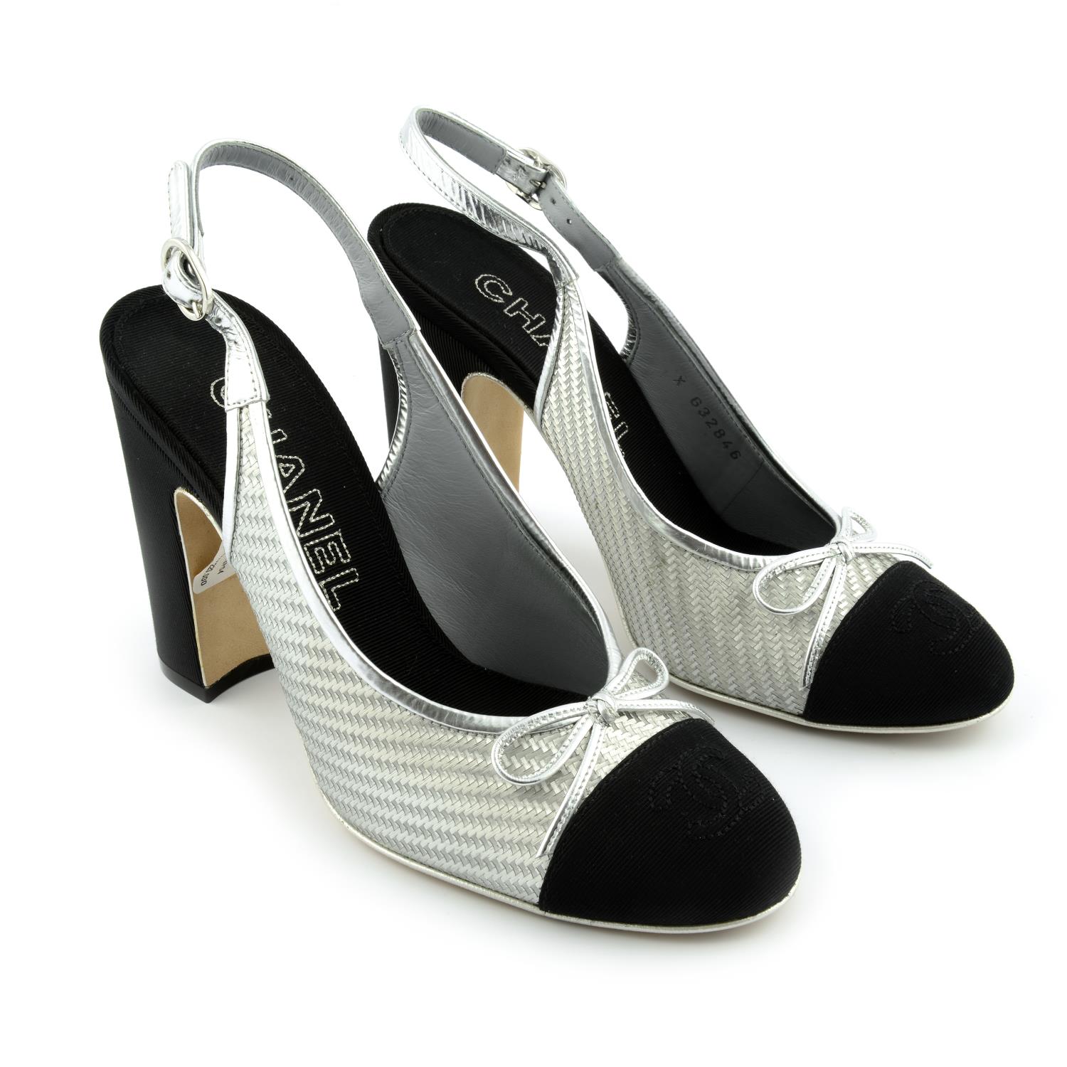 CHANEL - a pair of silver and black block heeled sandals.