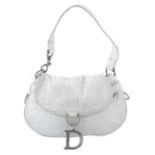 CHRISTIAN DIOR - a white leather cannage handbag.